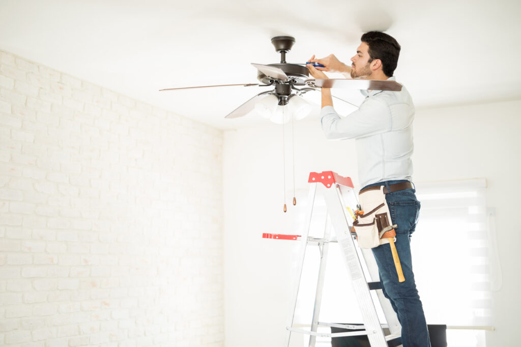 electrician installing a ceiling fan